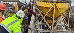Aerial electrical and telecommunication utilities were relocated underground throughout portions of the south end. Crews installing underground electrical and telecommunication duct bank. This segment crosses the Champlain Parkway and Briggs Street.