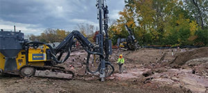 Crews drilling in preparation for blasting to remove ledge along the east side of Briggs Street just south of Flynn Avenue.