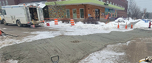 Temporarily patching the roadway surface on Briggs Street during winter drainage work.