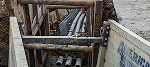 Aerial electrical and telecommunication utilities were relocated underground throughout portions of the south end. Crews installing underground electrical and telecommunication duct bank. This segment crosses the Champlain Parkway and Briggs Street.